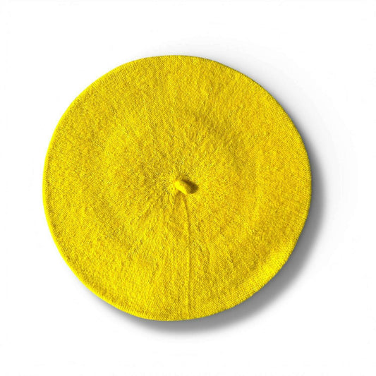 a yellow beret on a white background