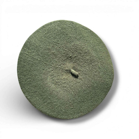 a green powdered object with a small hole