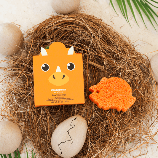 a small box with a dinosaur face in a nest with eggs