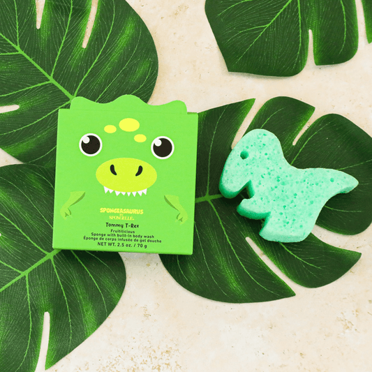 a green box with a dinosaur face on top of a leaf