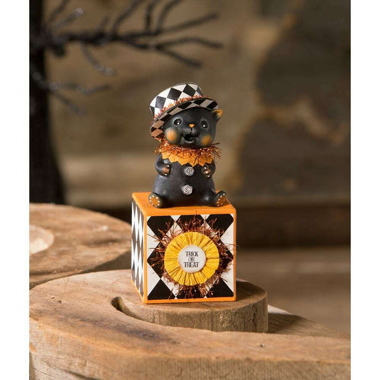 a black cat figurine on a cube