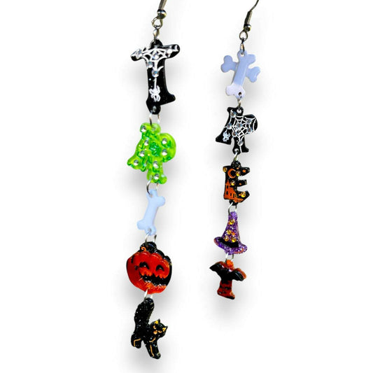 a pair of earrings with different colored objects