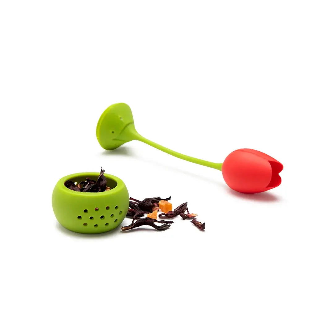 a green and red tulip shaped tea strainer with a red flower