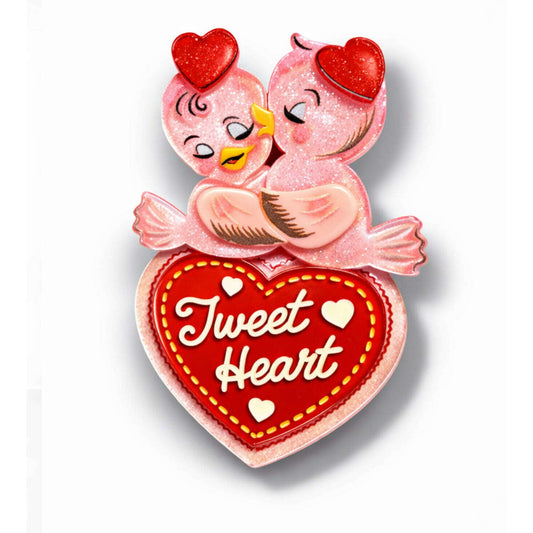 a pink bird with a red heart