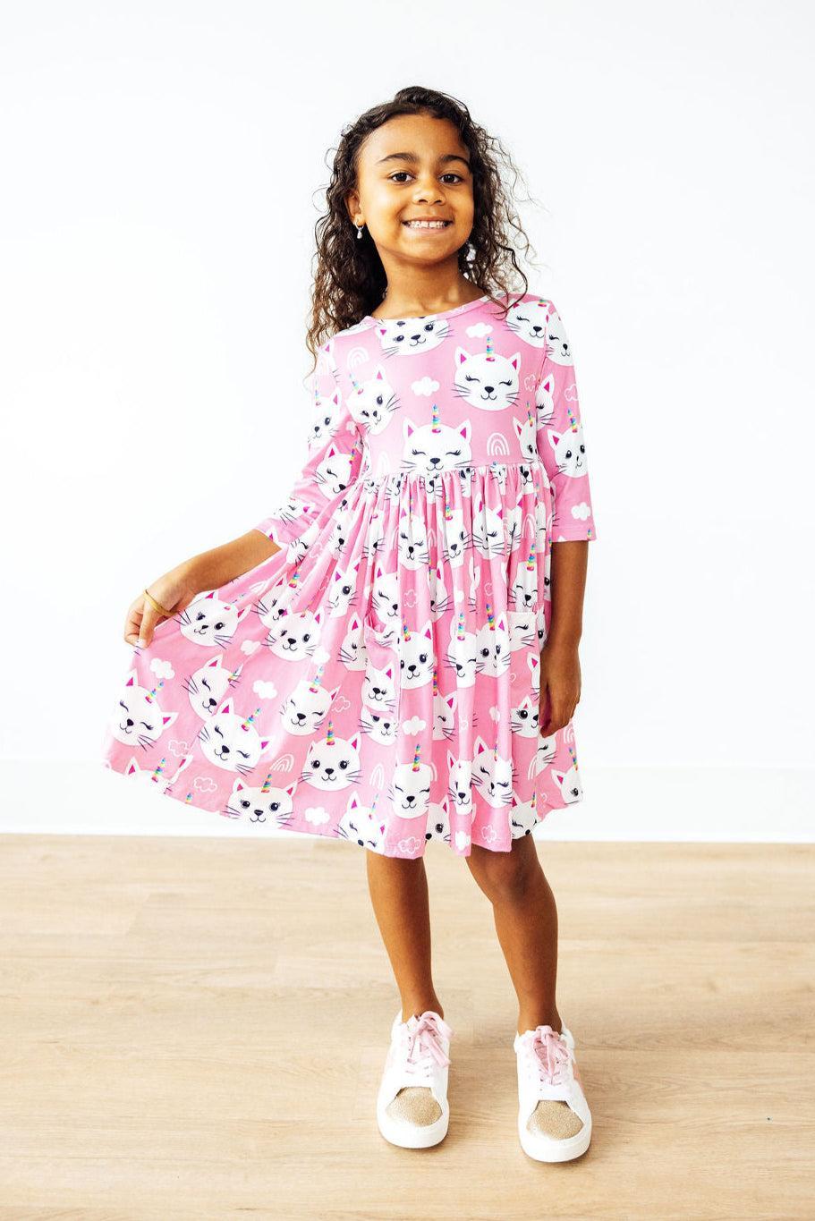 a girl in a pink dress