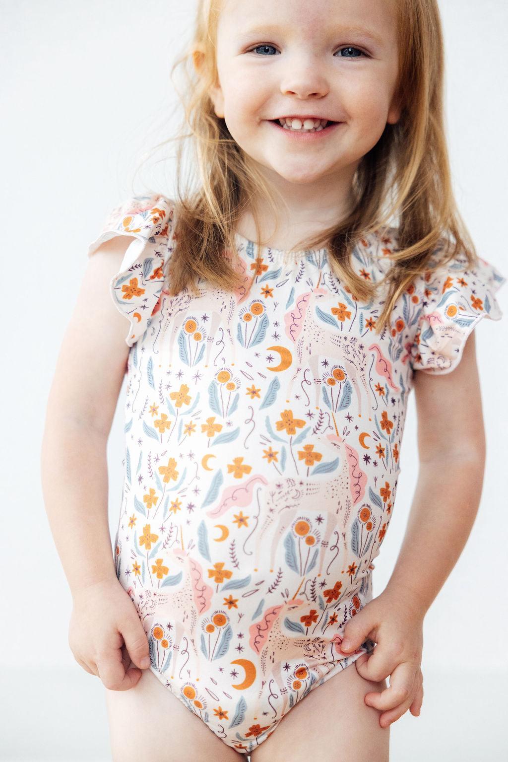 a girl wearing glasses and smiling