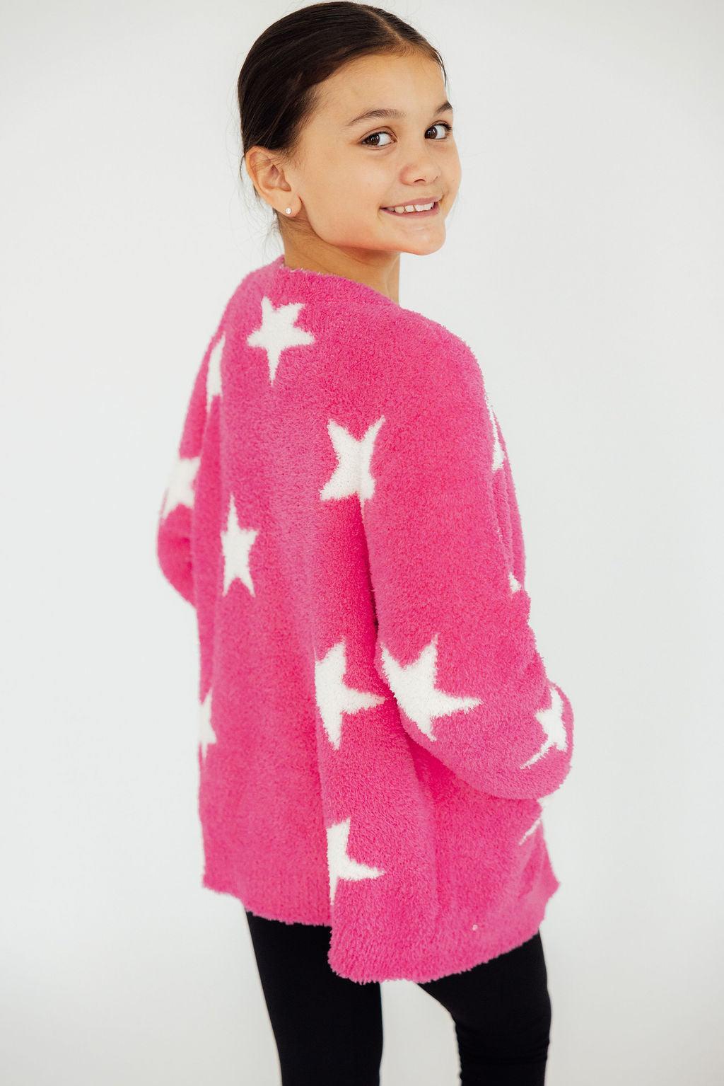 a girl in a pink sweater