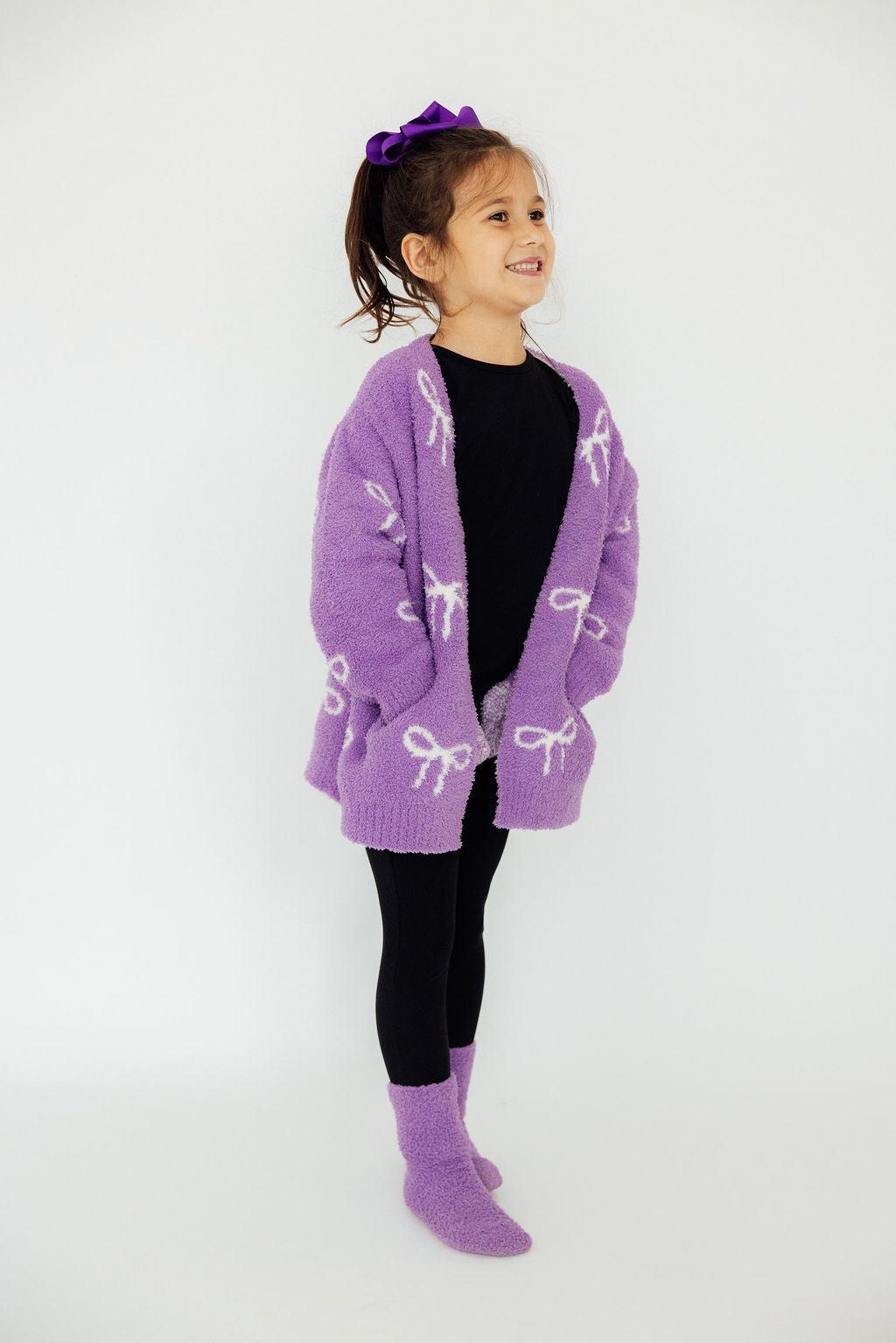 a girl in a purple sweater