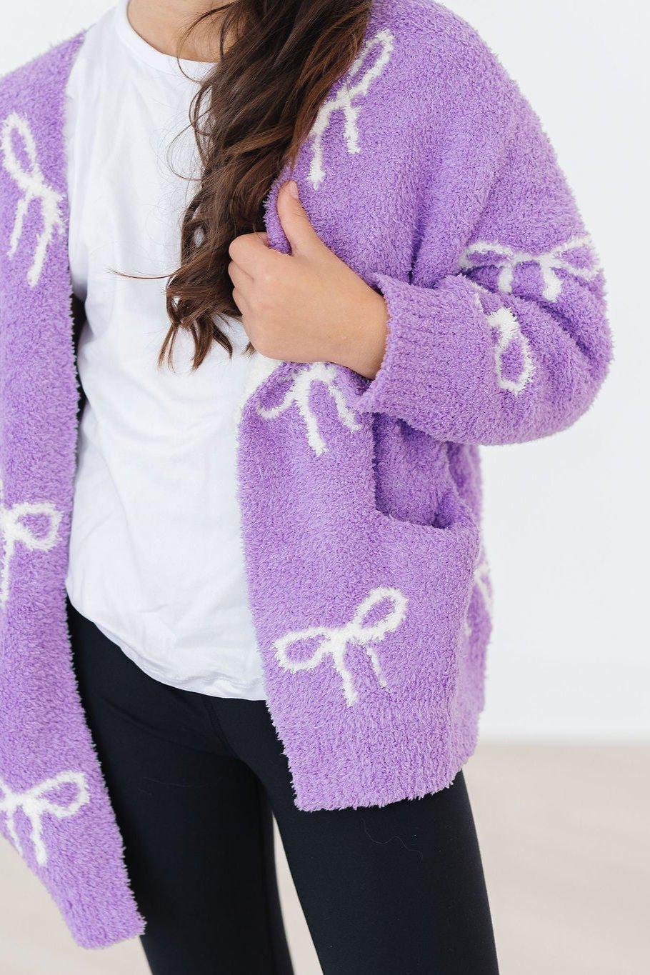 a woman wearing a purple sweater