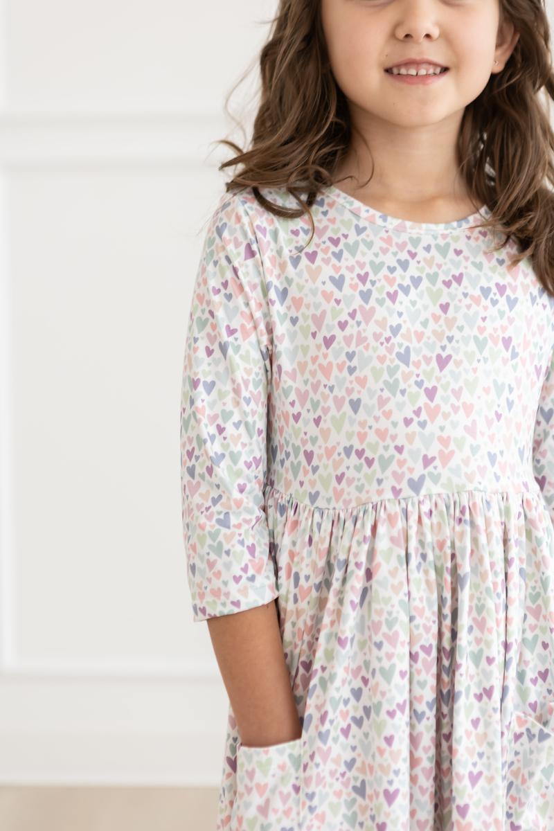 a girl wearing a dress with hearts