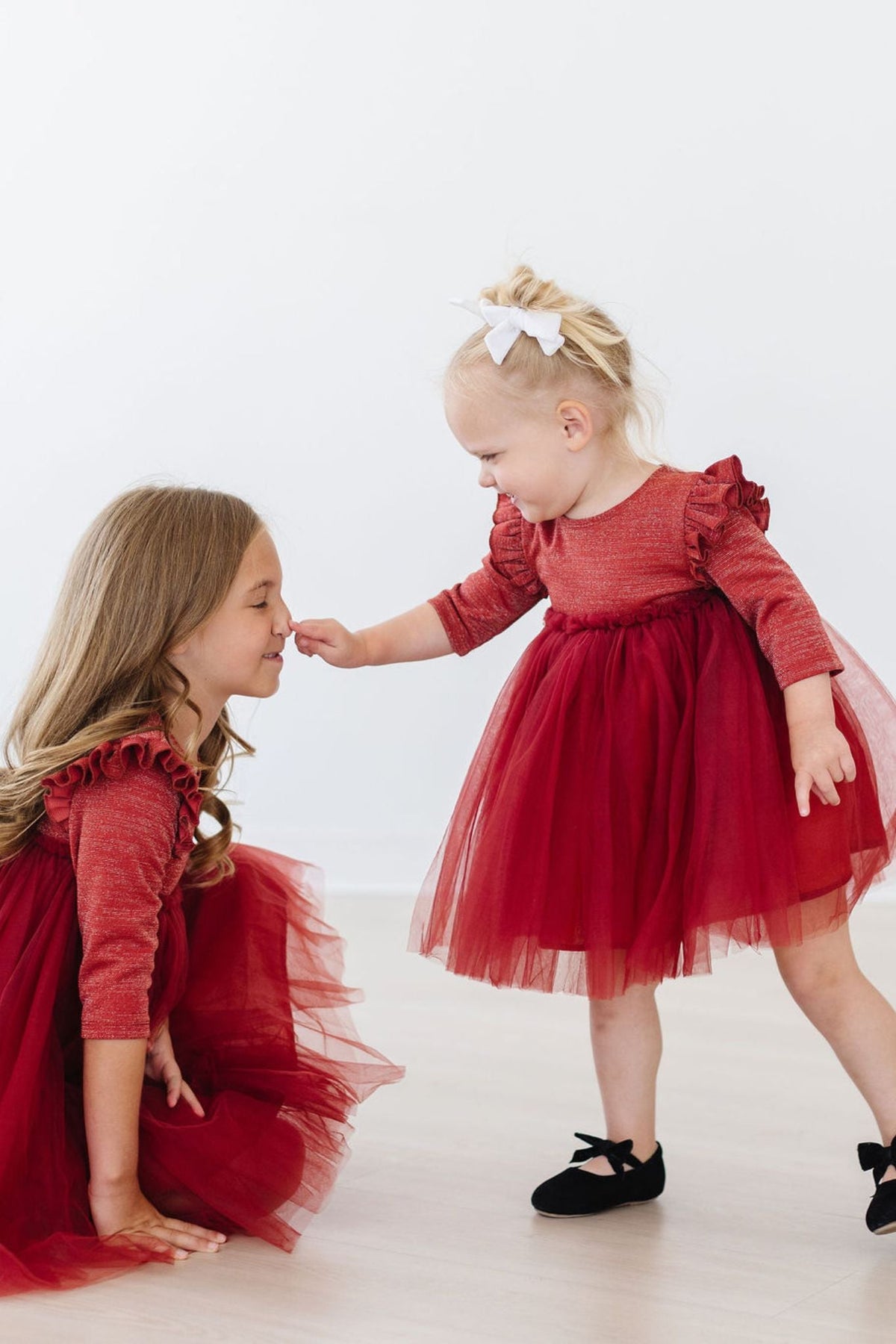 two girls in red dresses