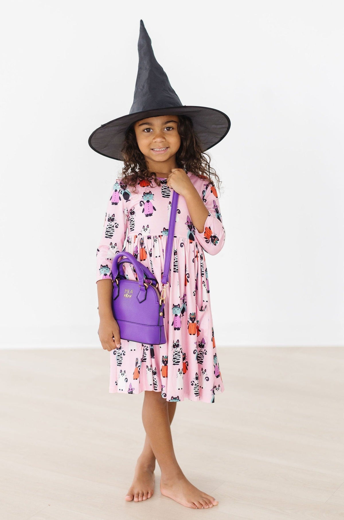 a girl wearing a hat and dress