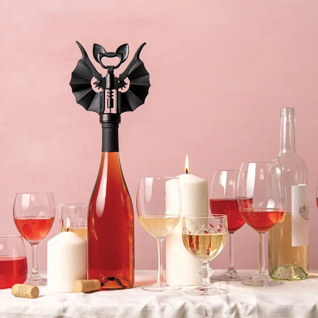 a group of wine glasses and a bottle with a corkscrew