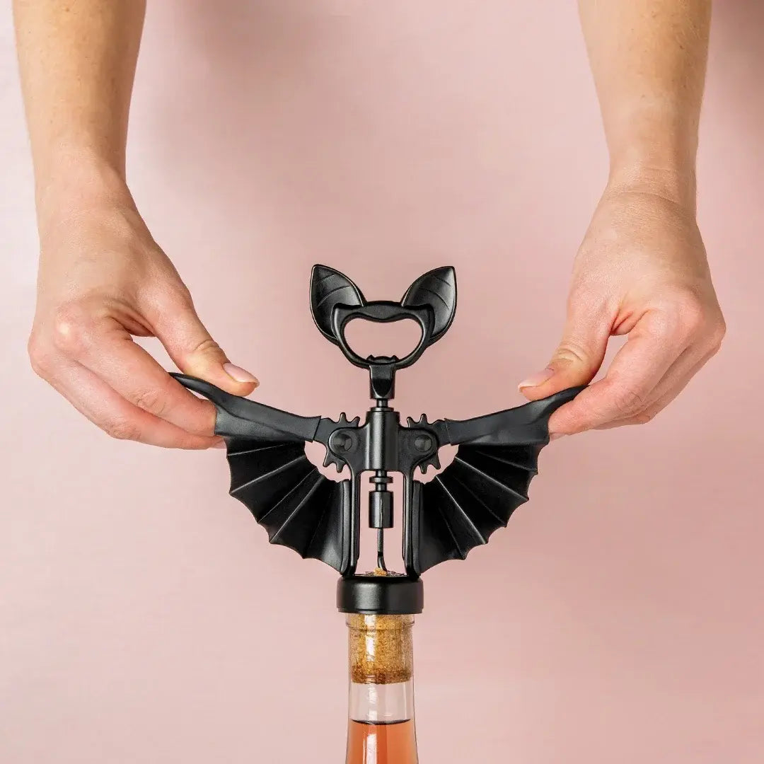 a person holding a corkscrew