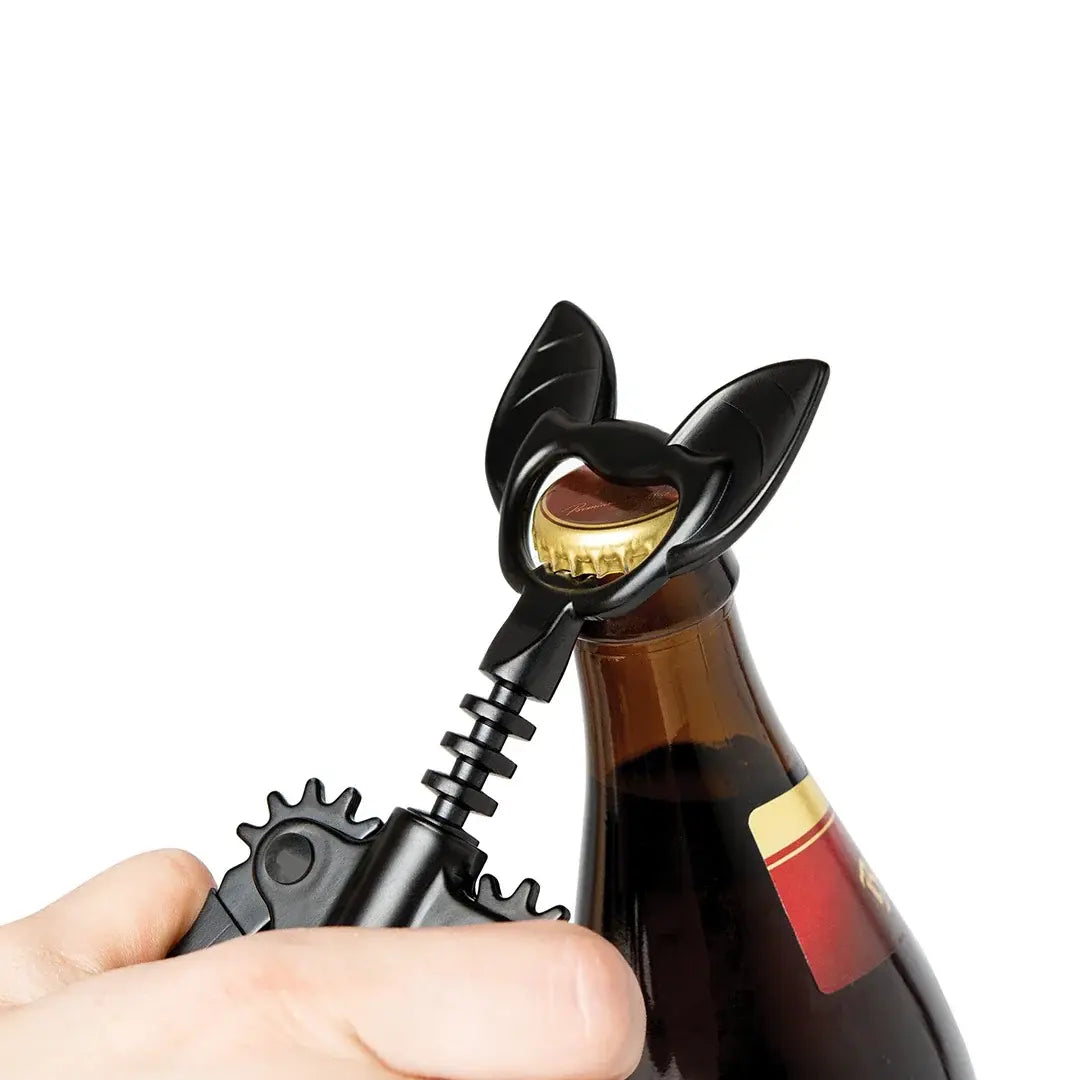 a hand holding a bottle opener