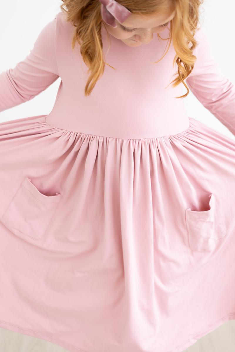 a woman wearing a pink dress
