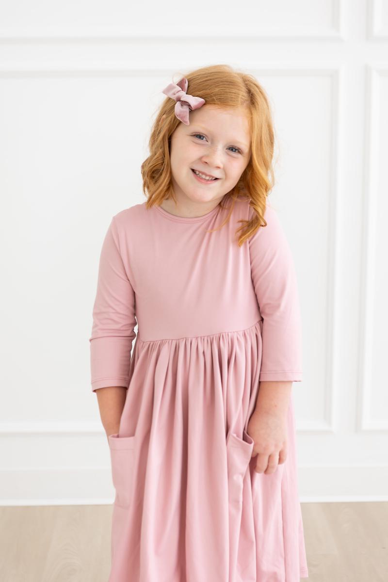 a girl in a pink dress