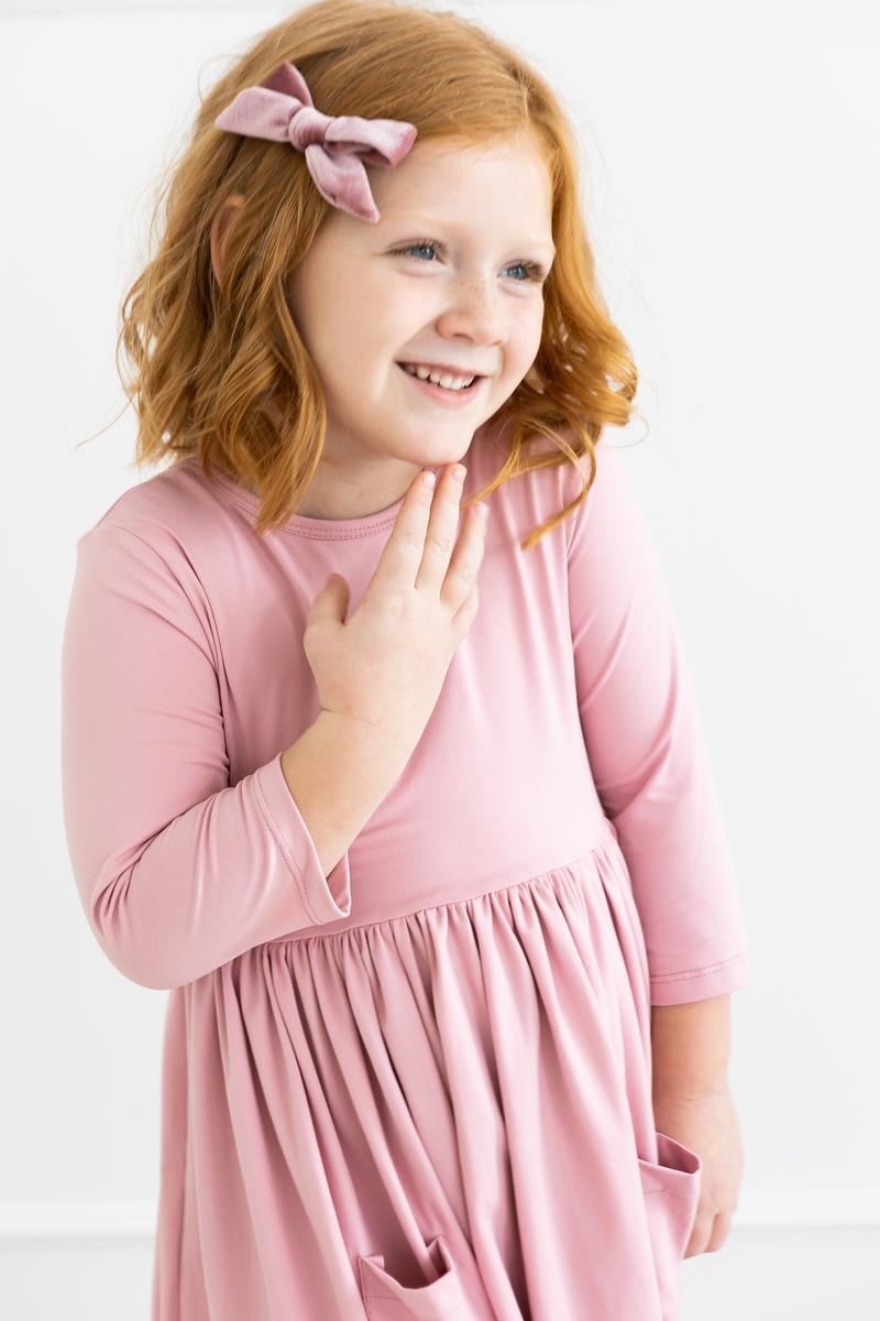 a girl in a pink dress