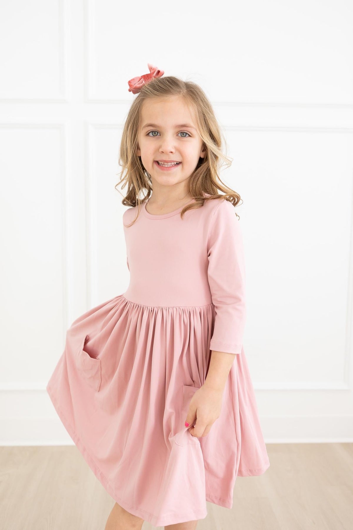 a girl in a pink dress