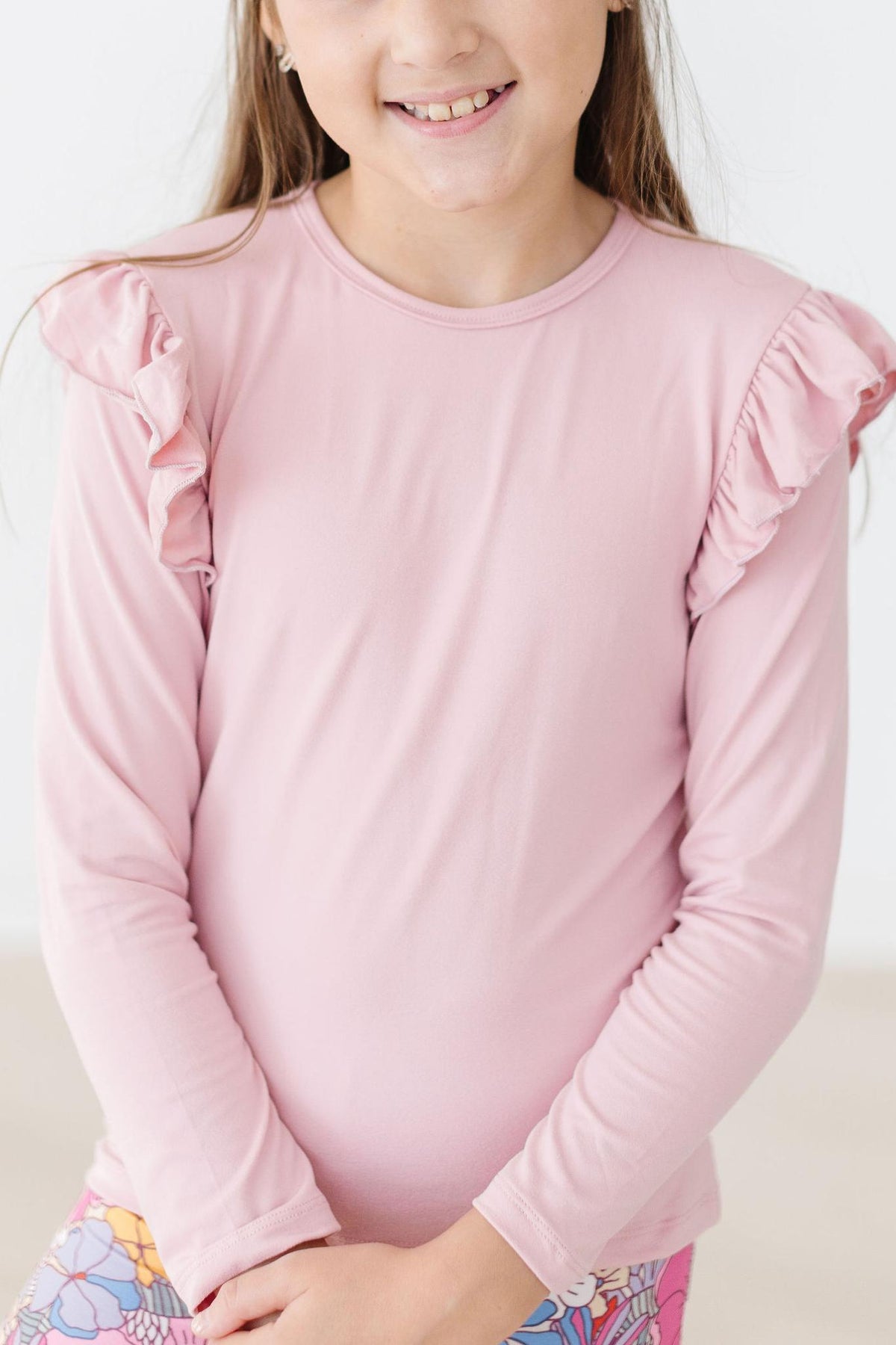 a girl wearing a pink shirt