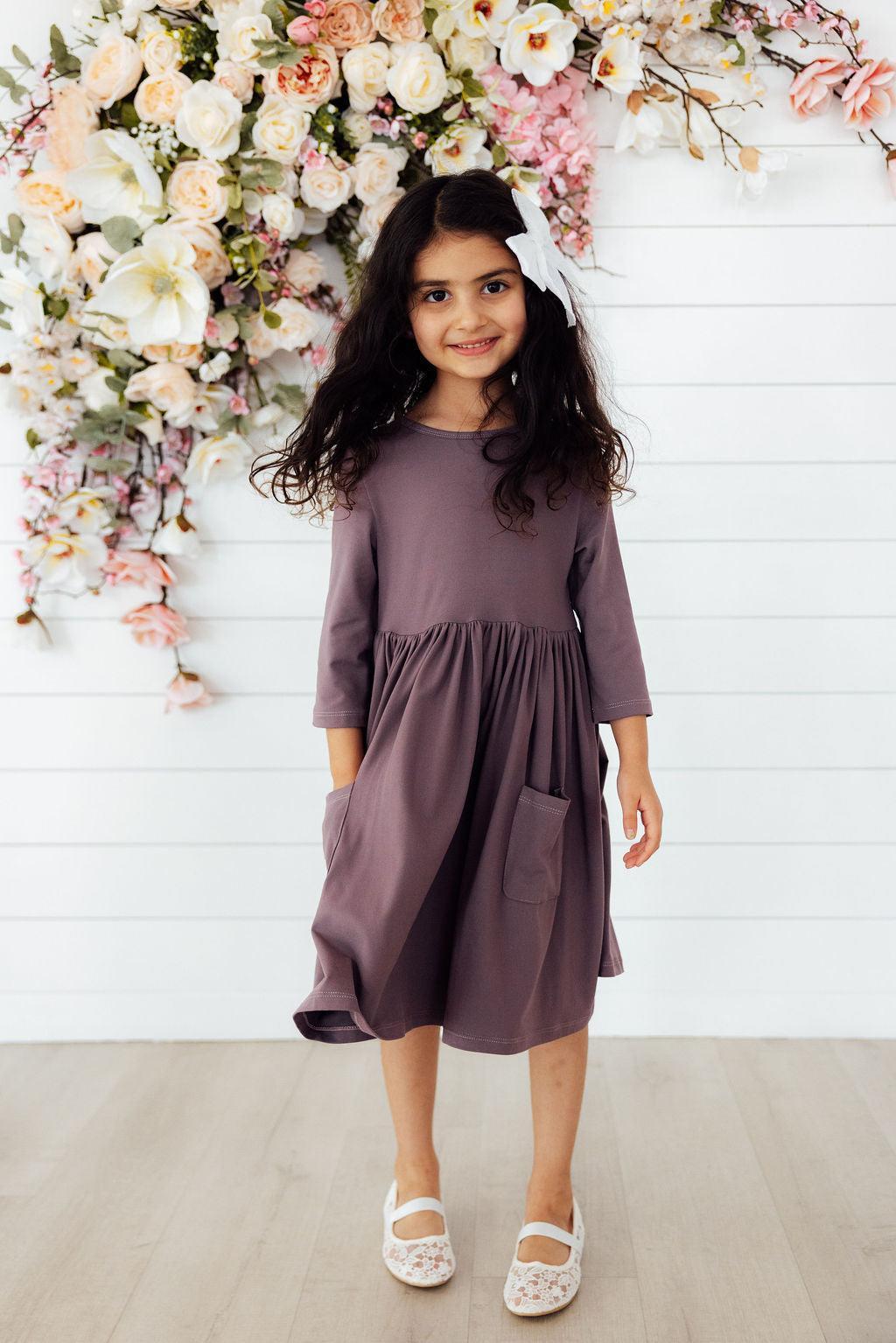 a girl in a purple dress
