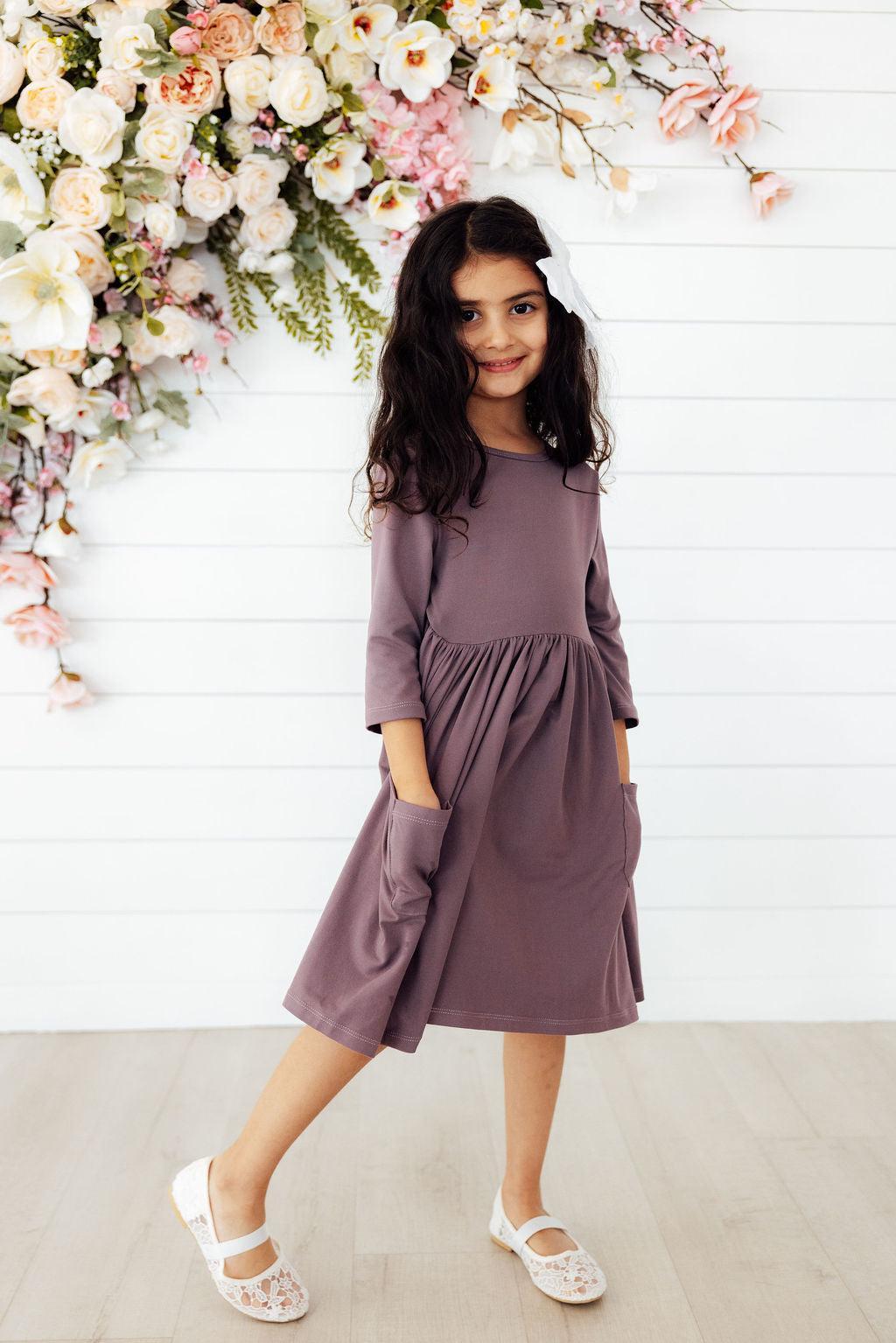 a girl in a purple dress