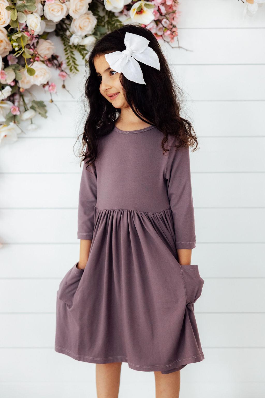a girl in a purple dress
