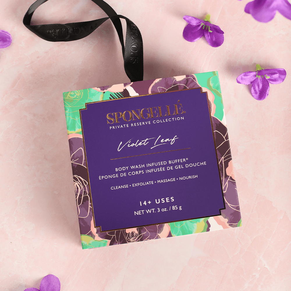 a purple box with a black ribbon and purple flowers