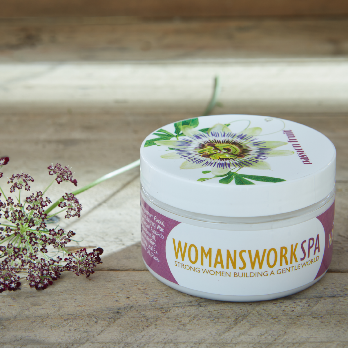 a jar of cream next to a plant