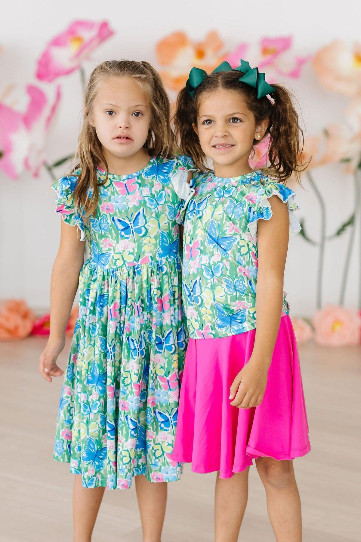 two girls wearing matching outfits