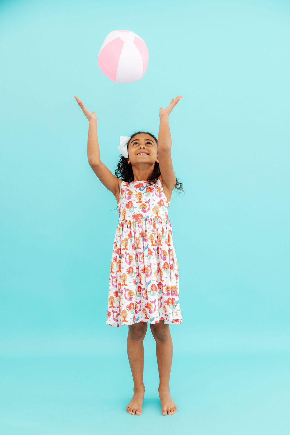 a girl in a dress with a ball