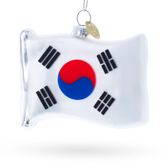 a white flag shaped christmas ornament