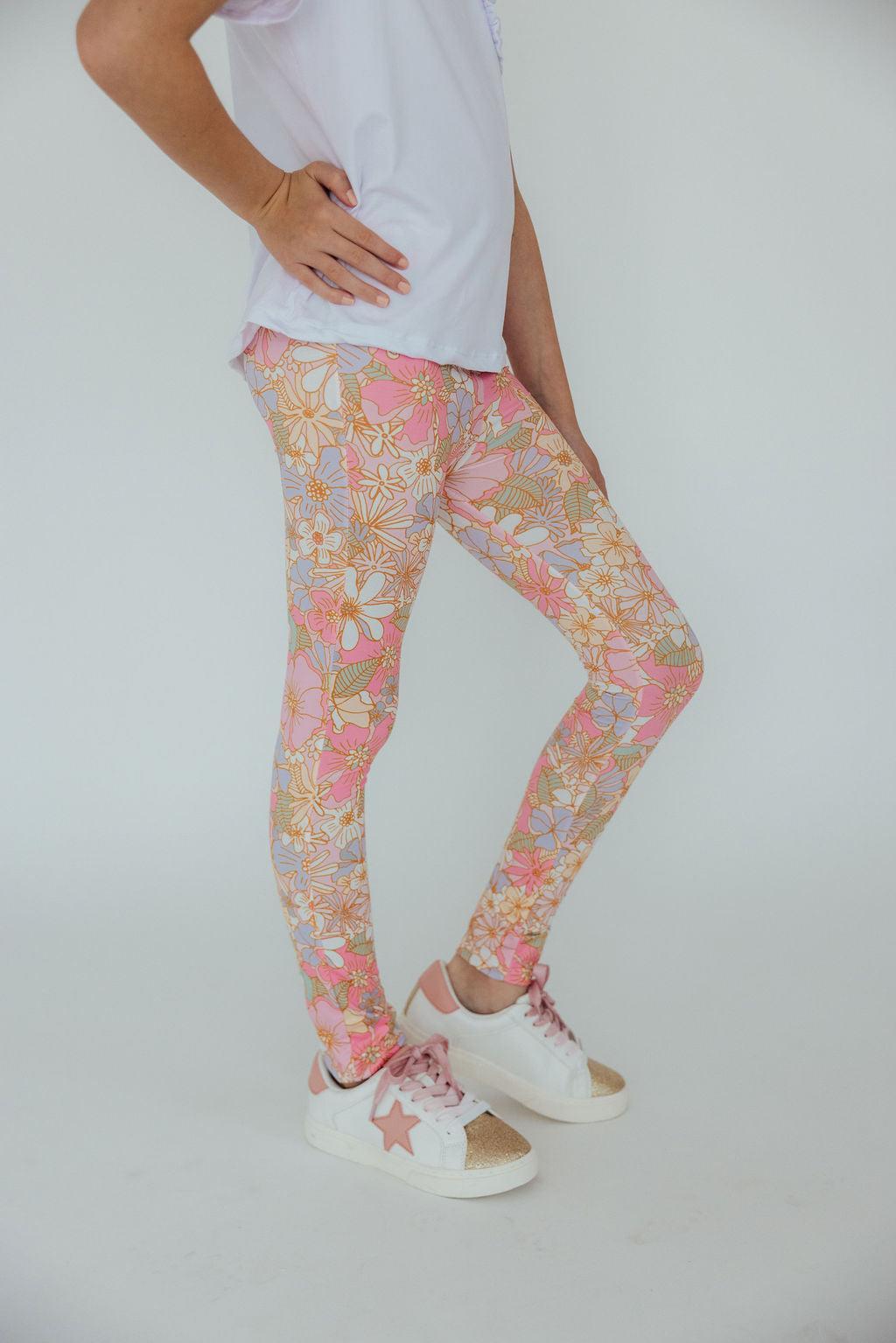 a person wearing leggings and white shirt