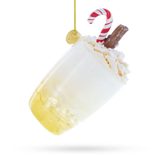 a glass with a drink and candy cane