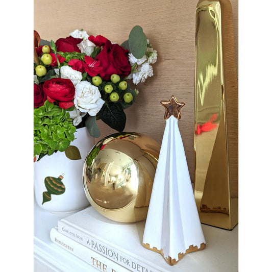 a gold and white objects on a white shelf