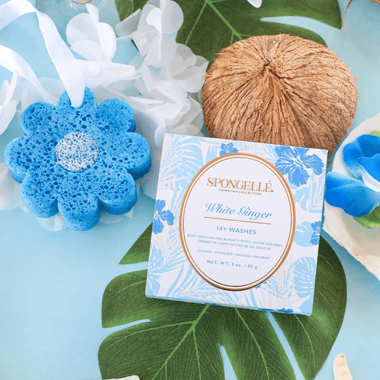 a blue and white sponge next to coconut and flowers