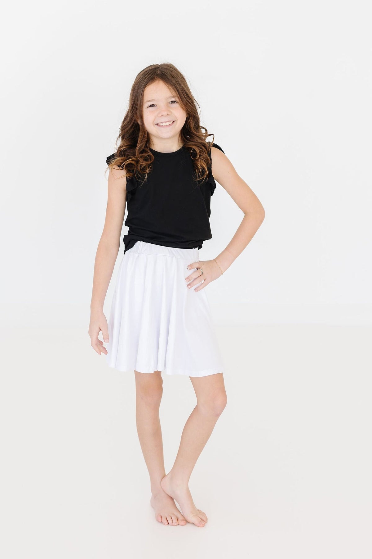 a girl in a white skirt and black shirt