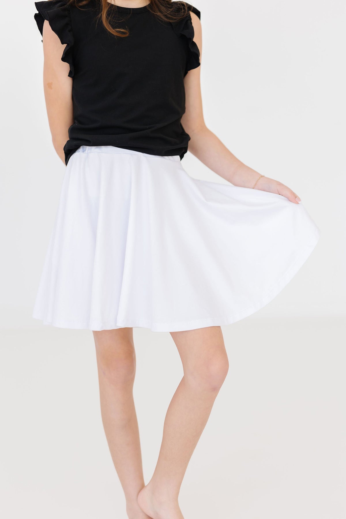 a person wearing a white skirt
