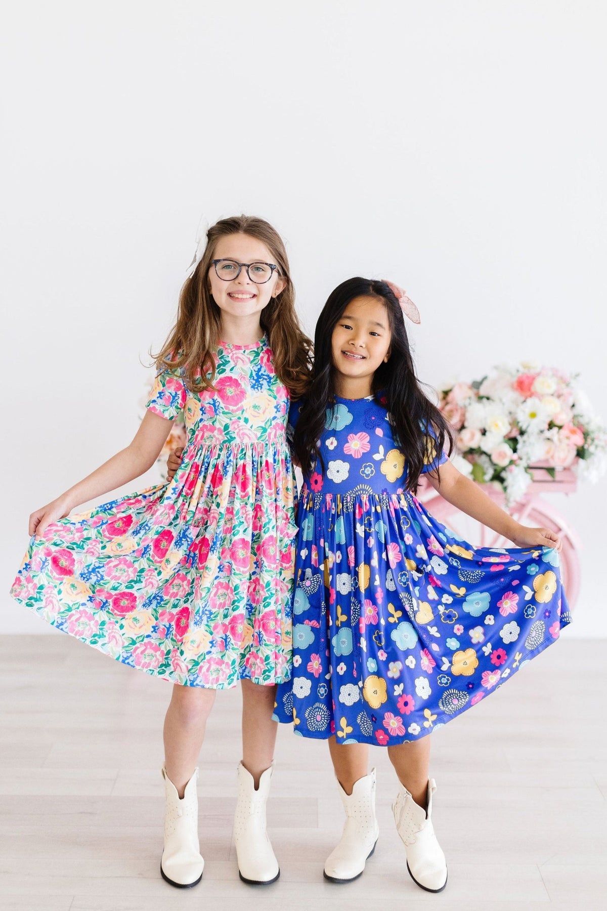two girls wearing dresses