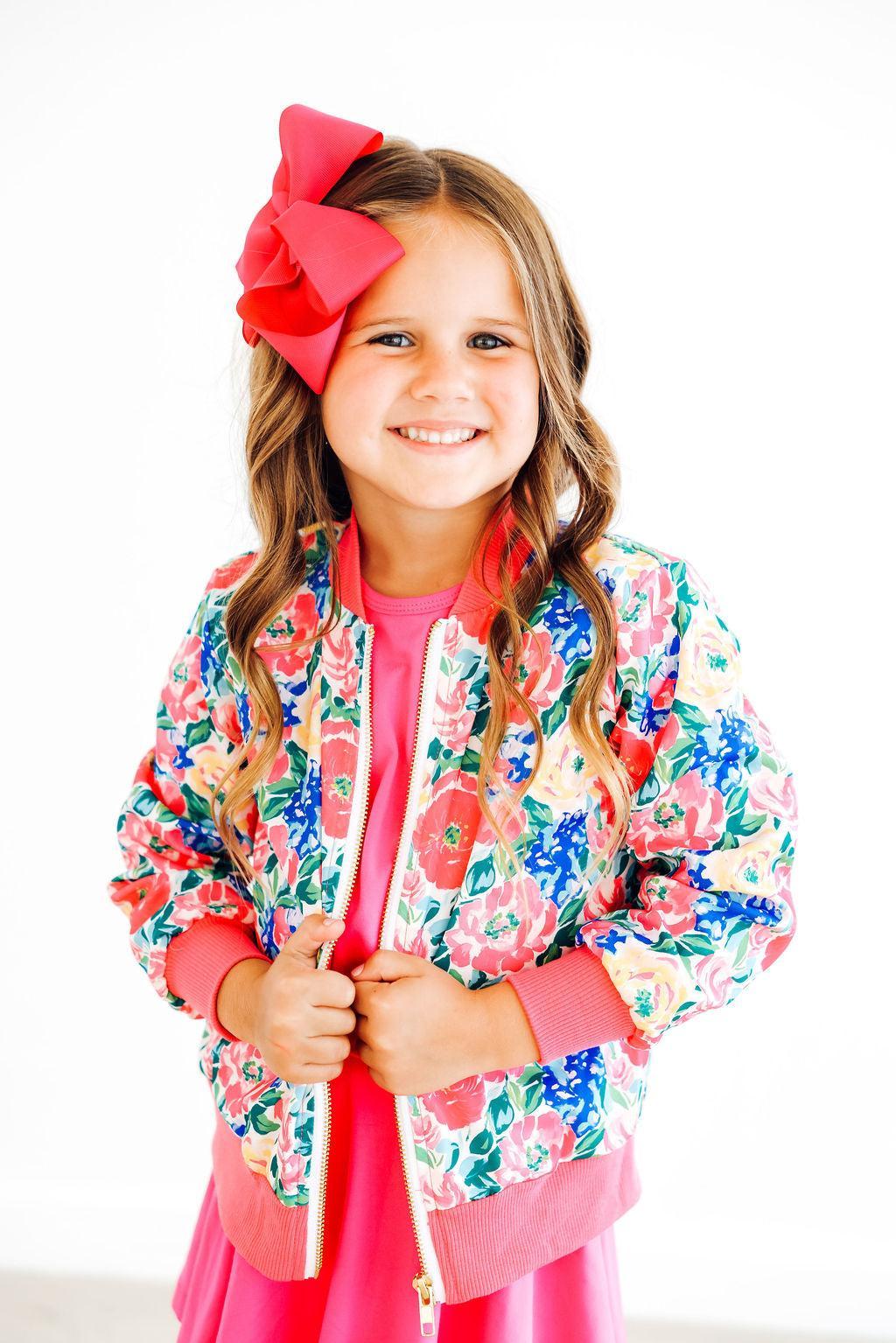 a girl with a red bow in her hair
