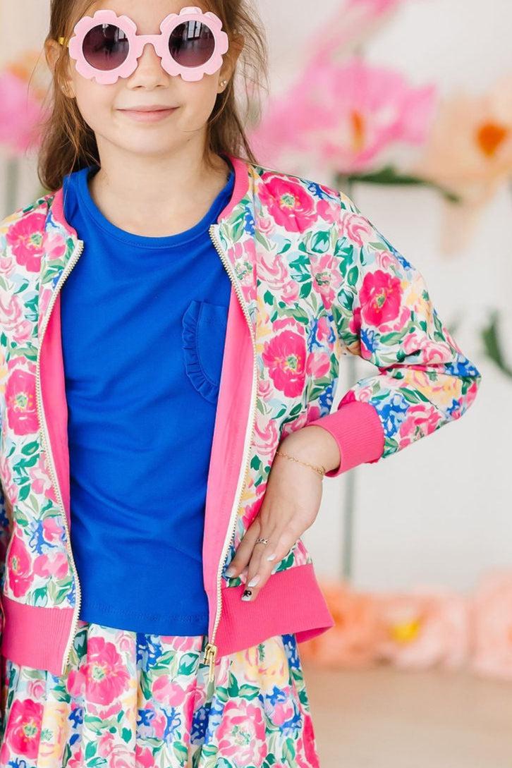 a girl in a pink and blue jacket