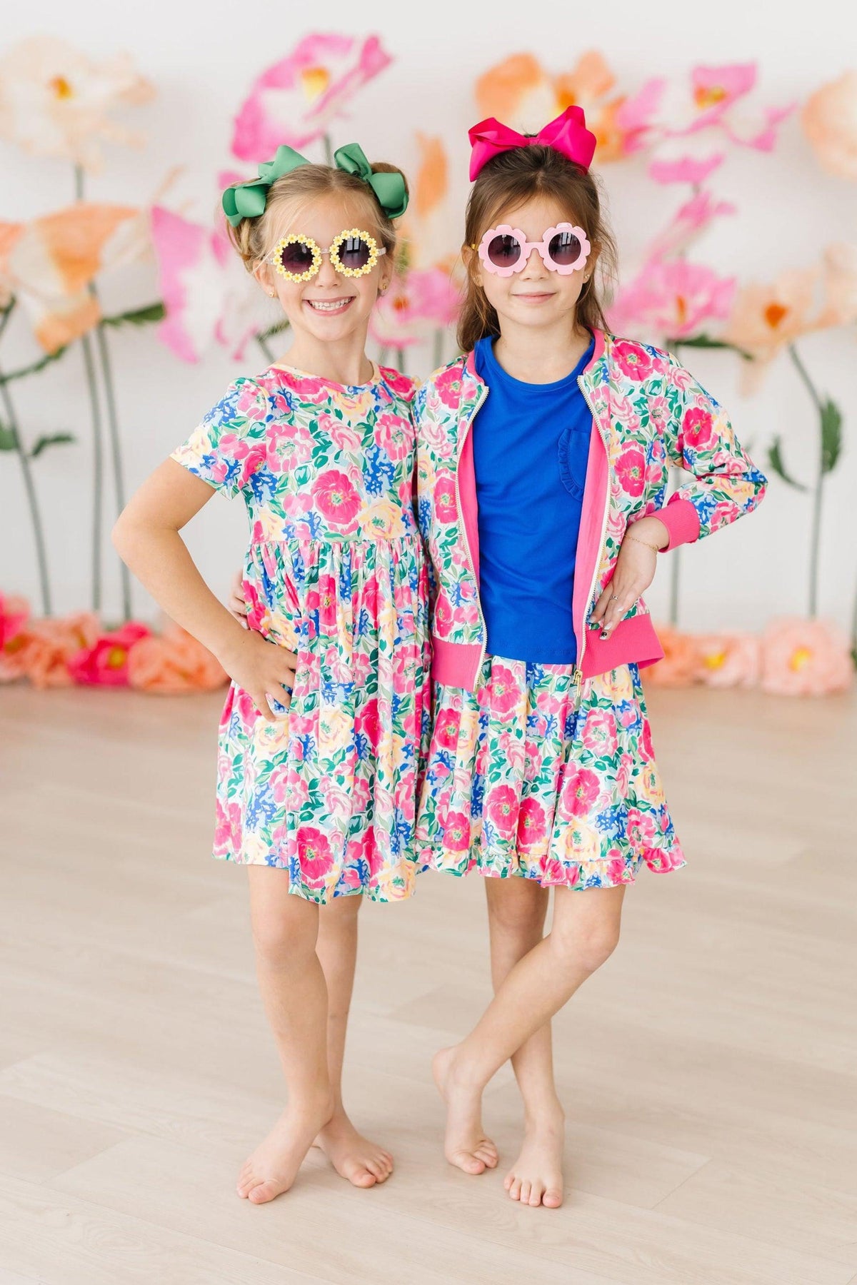 two girls wearing sunglasses and posing for a picture