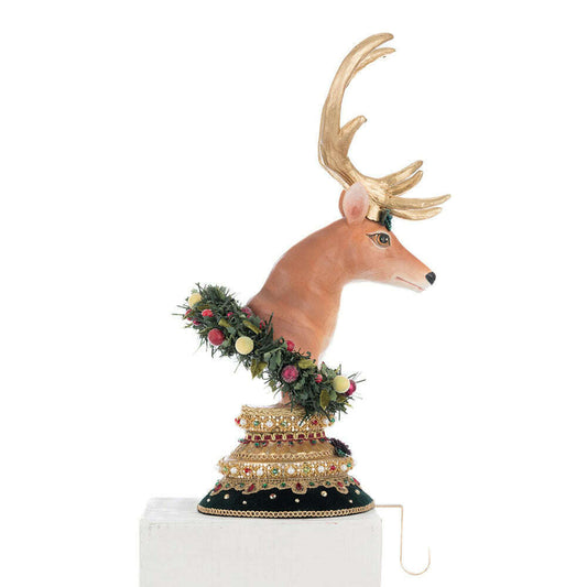 a statue of a deer with a garland of flowers