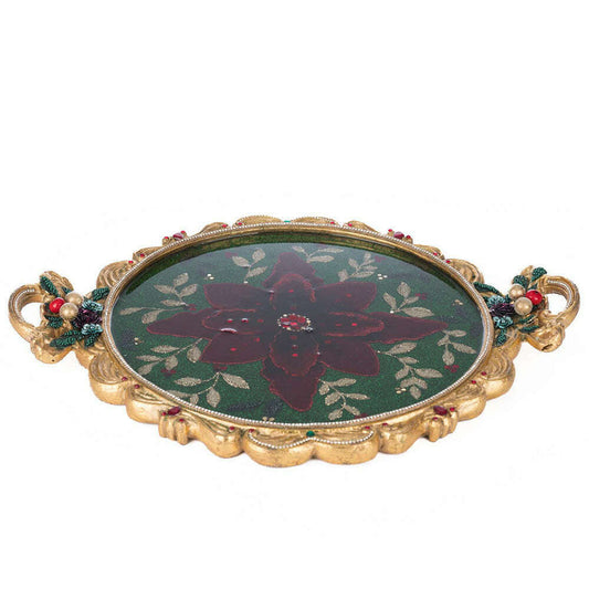 a green and gold plate with a red flower on it