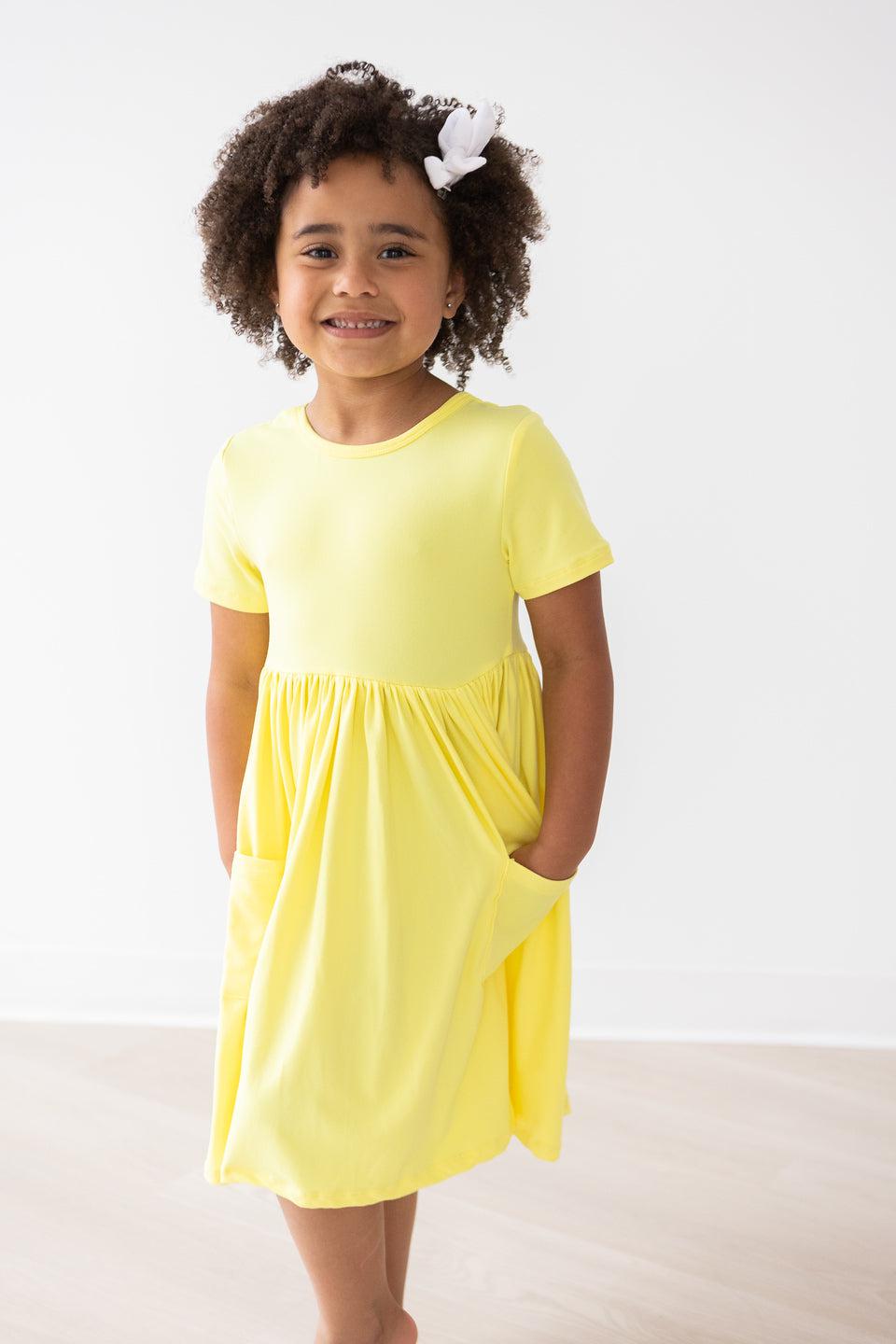 a girl in a yellow dress