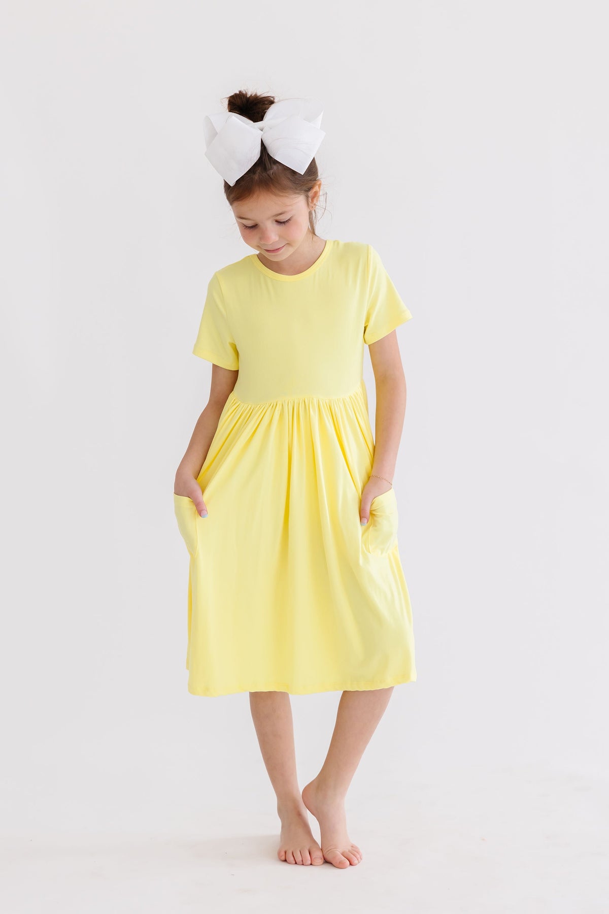 a girl in a yellow dress