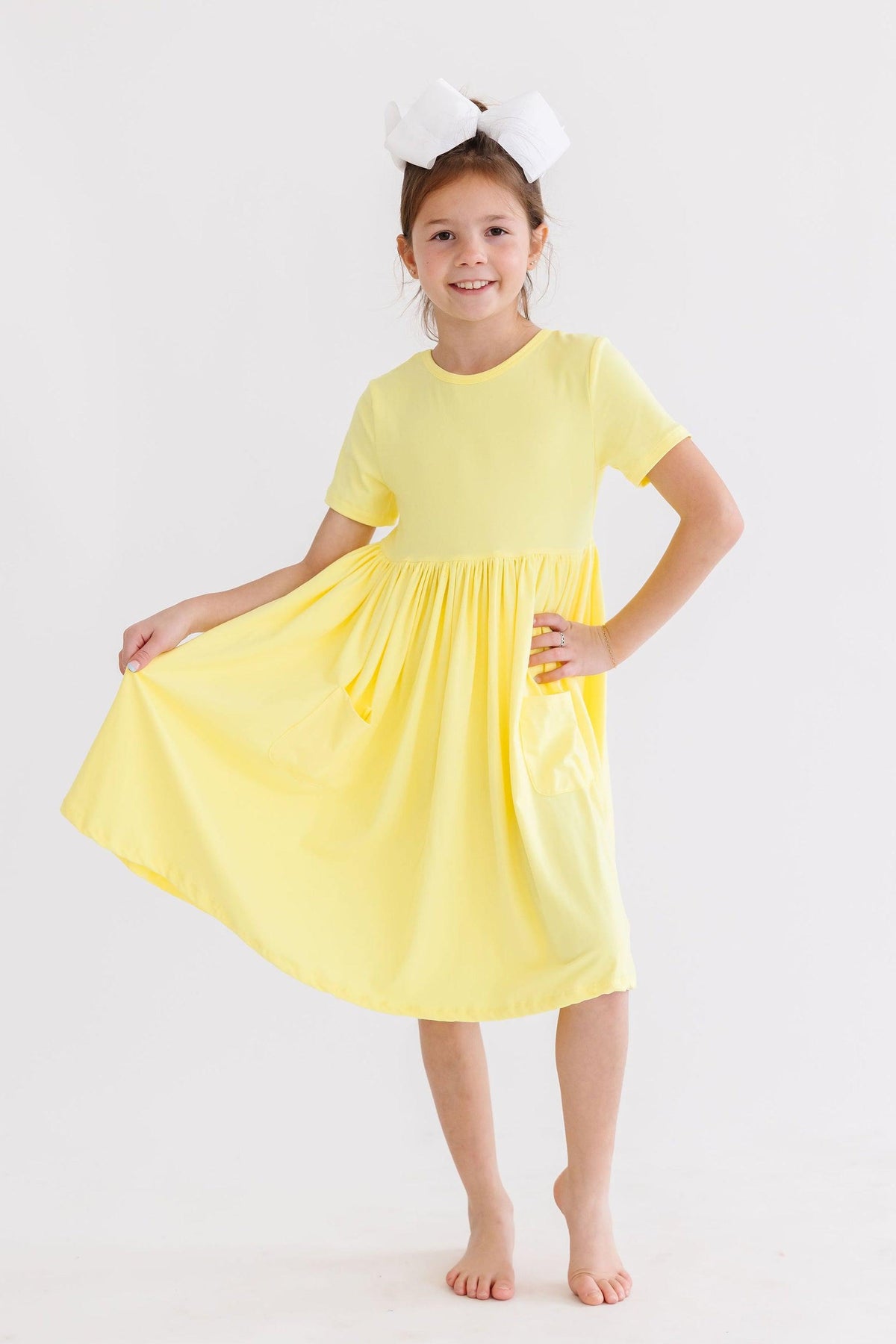 a girl in a yellow dress