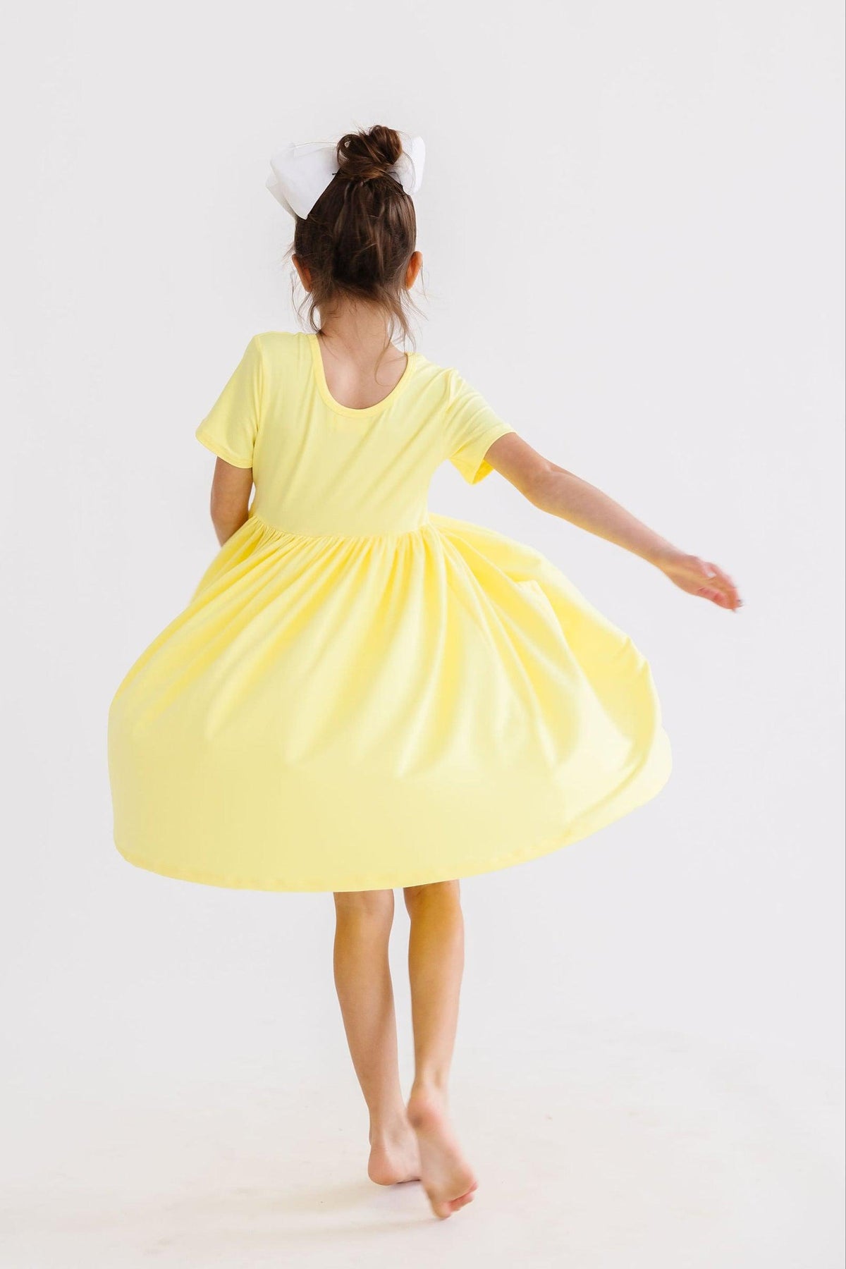 a girl in a yellow dress