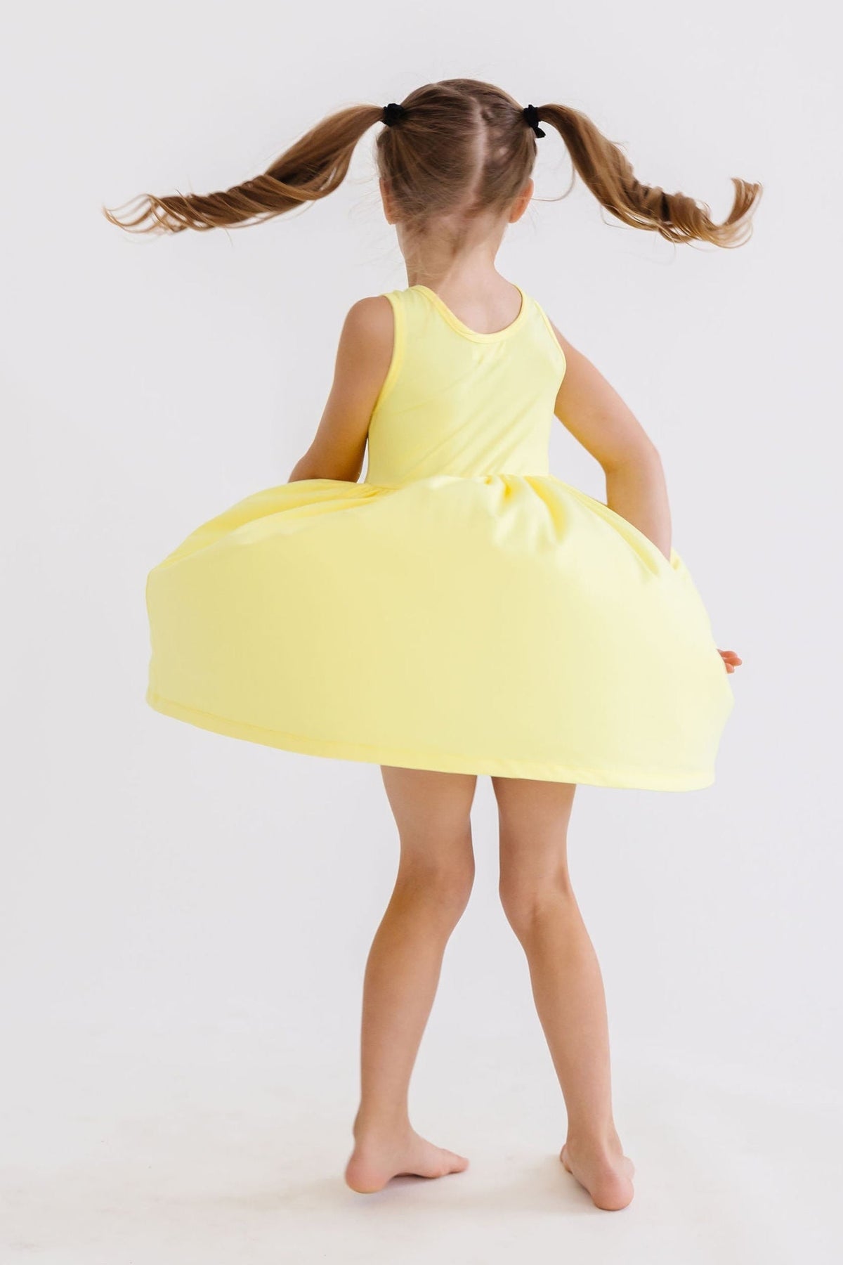 a girl in a yellow dress