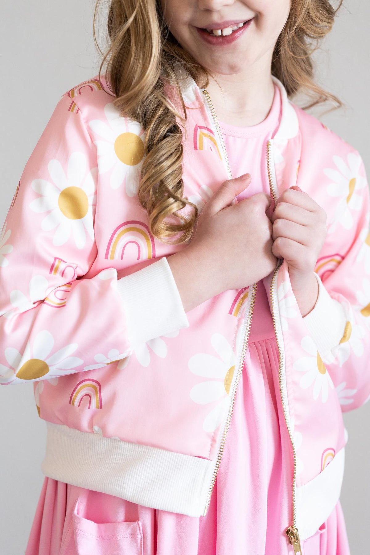 a girl wearing a pink jacket